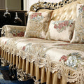 Copridivano beige con motivo floreale e frange